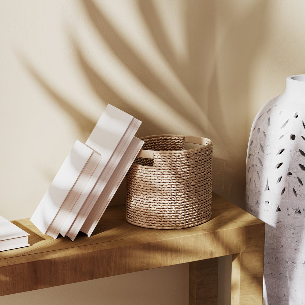 Books, Wicker Basket and Concrete Vase with Palm Shadow